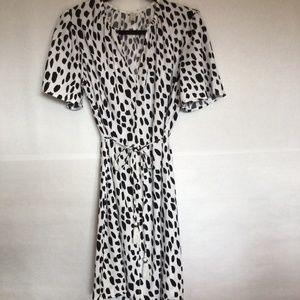 White dress with black spots and fringed belt